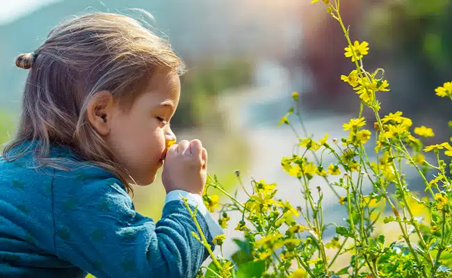 Young girl smelling flowers